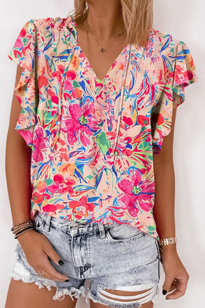 Floral flutter sleeve tie-neck blouse with a V-neckline and ruffle details.