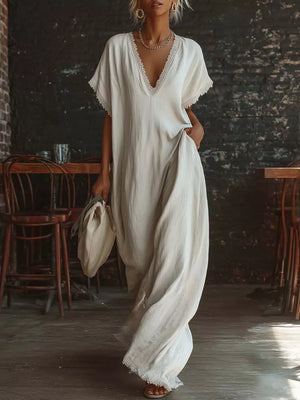 White lace-trimmed V-neck maxi dress with pockets and short sleeves.