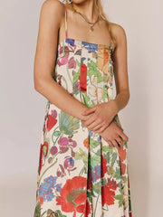 Maxi dress in ivory with vibrant floral print, gathered bodice, and spaghetti straps.