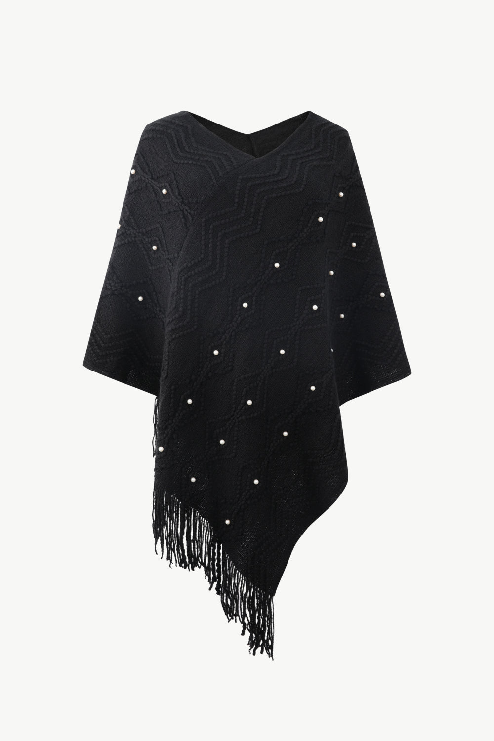 Black knit poncho with geometric pattern, pearl embellishments, and fringe detail.