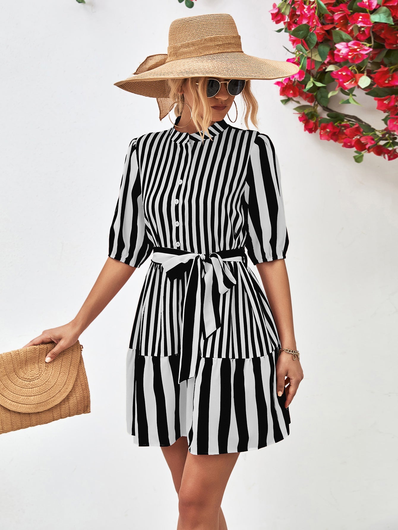 Black and white striped shirred waist dress with tie belt and tiered skirt.