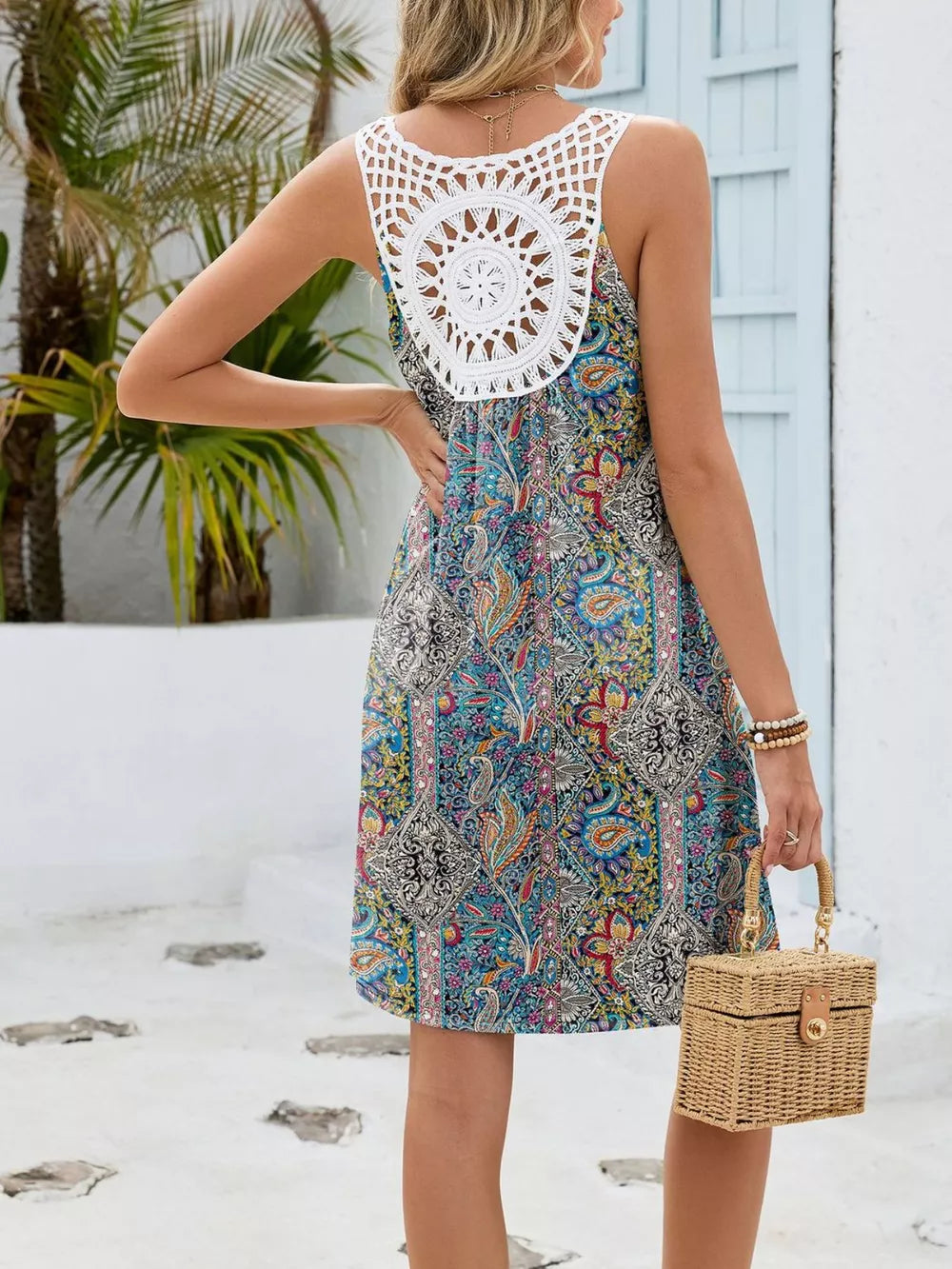 Botanical print mini dress with white crochet back detail and cutout.