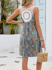 Botanical print mini dress with white crochet back detail and cutout.