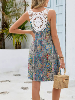 Botanical print mini dress with white crochet back detail and cutout.