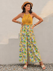 Gold crochet halter jumpsuit with a vibrant floral print palazzo pant