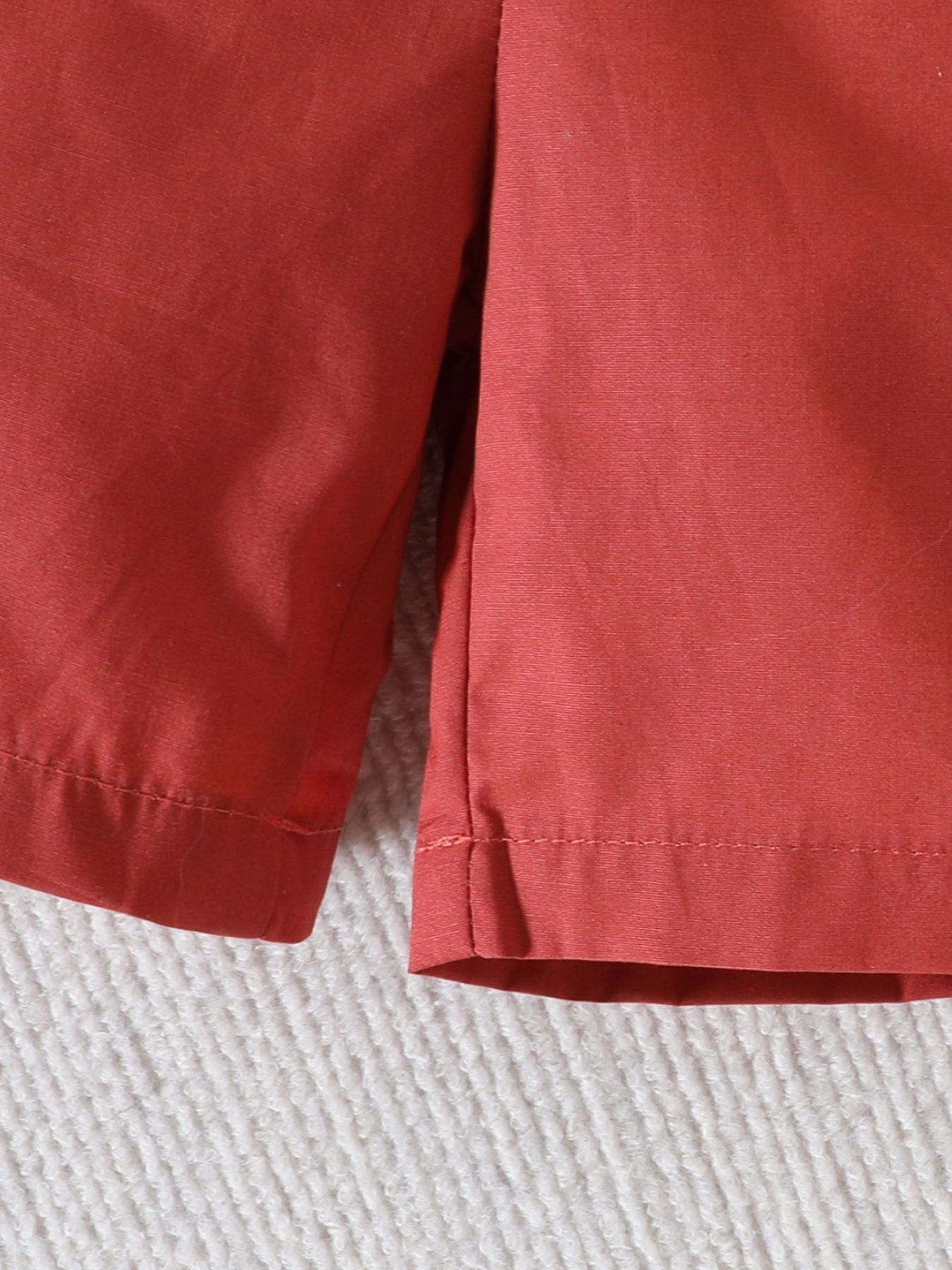 Toddler shorts set in light brown cotton with dinosaur print.