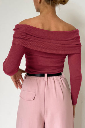Deep Rose ribbed knit off-the-shoulder top with draped neckline and long sleeves.