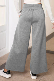Heather gray palazzo joggers with elastic waist and center seam detail.