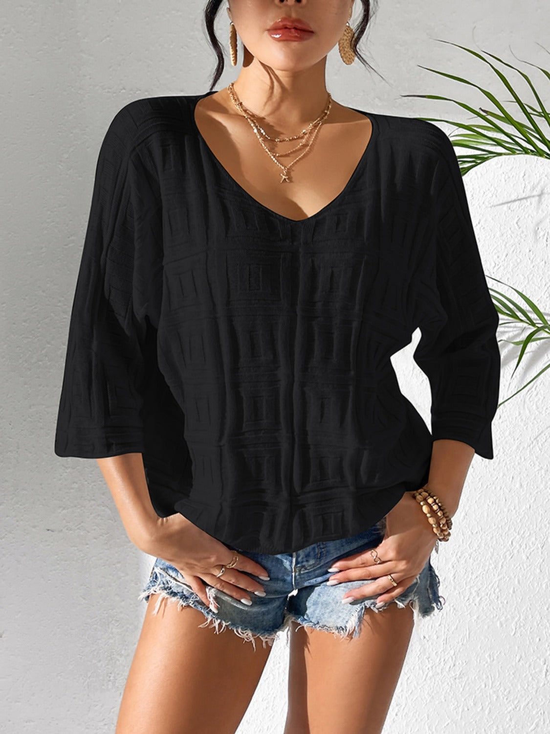 Black textured knit dolman sleeve top with V-neck and 3/4 sleeves.