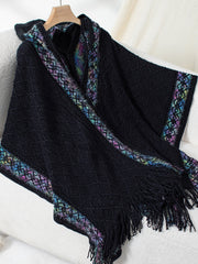 Black acrylic knit hooded wrap coat with colorful embroidered trim and fringe.