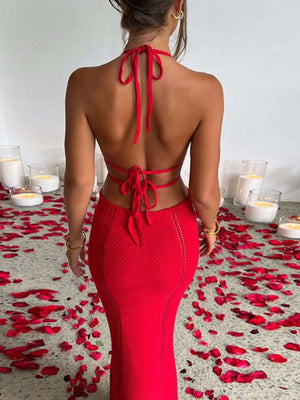 Deep red backless knitted maxi dress with halter tie and cutout details.