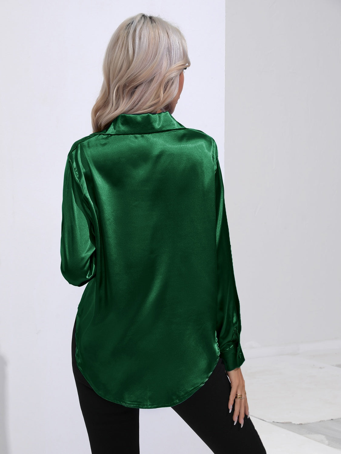 Dark green satin tie-front blouse with a collared neckline and long sleeves.
