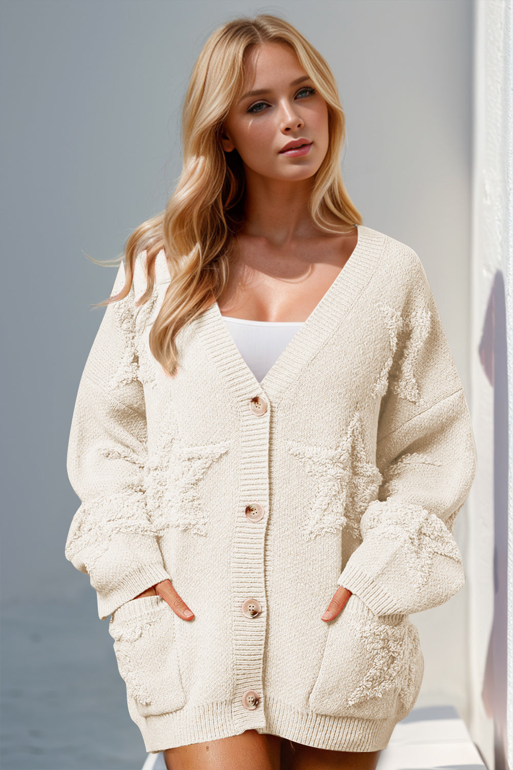 Beige textured starburst pocket cardigan with button front and v-neck.