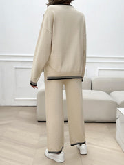Beige knit lounge set with black ribbed trim on neckline, cuffs, and hem.