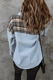 Light blue denim shirt jacket with brown plaid paneling on back, casual trucker style.