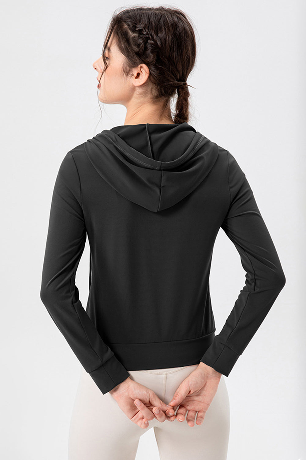 Black performance fit hoodie with long sleeves and a hood, shown from the back.