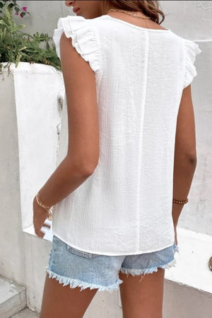 White embroidered trim flutter sleeve blouse with textured fabric.