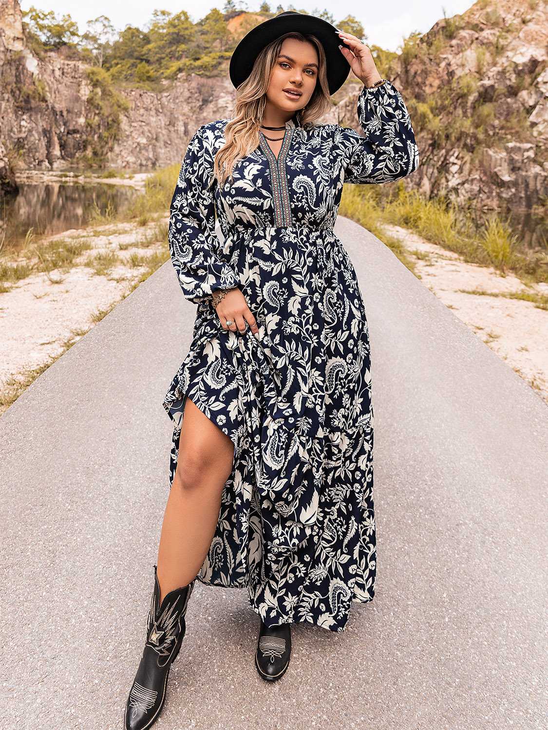 Dark navy paisley print maxi dress with tiered skirt and embroidered neckline.