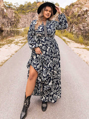 Dark navy paisley print maxi dress with tiered skirt and embroidered neckline.