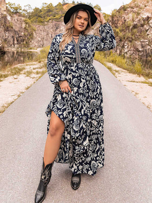 Dark navy paisley print maxi dress with tiered skirt and embroidered neckline.