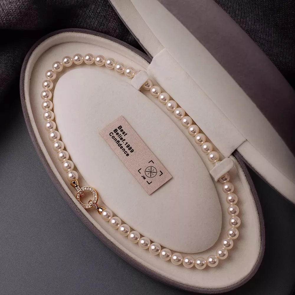 Cream pearl choker necklace with 18k gold clasp in jewelry box
