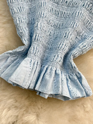 Light blue ruffled crop top with eyelet trim detail