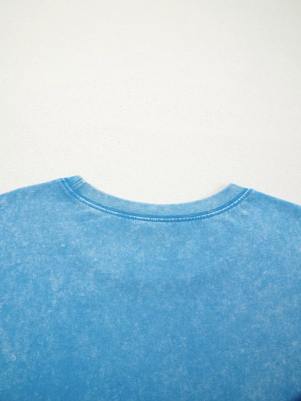 Mineral washed blue cotton crew neck t-shirt with a relaxed fit.