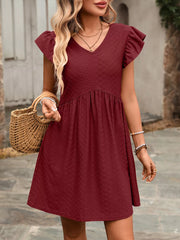 Burgundy a-line dress with ruffled sleeves and textured fabric.