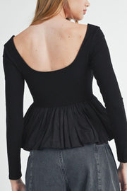 Black ribbed bodice peplum top with a scoop neck and long sleeves.