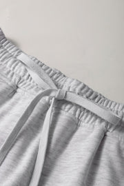 Light gray French terry skort with drawstring and elastic waistband detail.