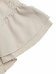 Beige maternity overshirt with ruffled sleeve detail and layered fabric.