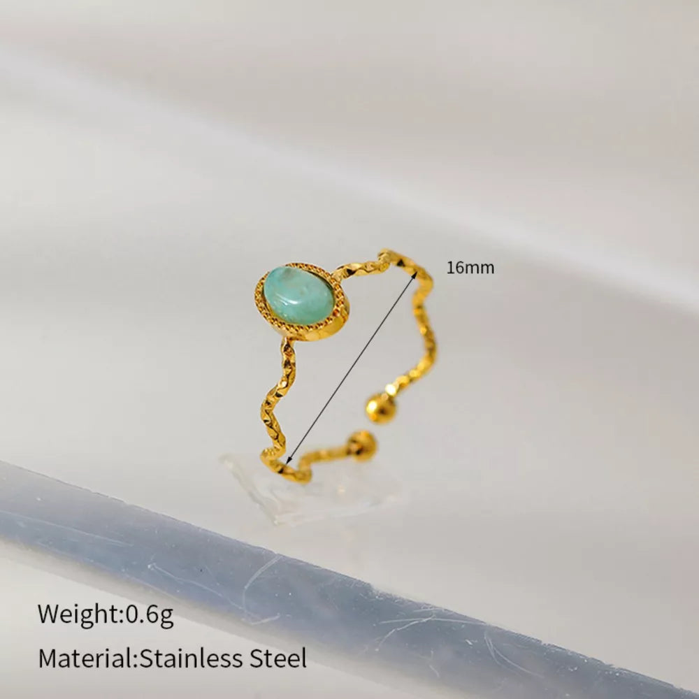 Wavy gold-plated ring with oval turquoise stone, adjustable stainless steel band