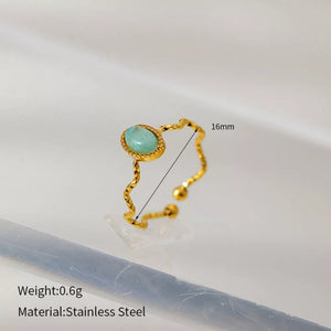 Wavy gold-plated ring with oval turquoise stone, adjustable stainless steel band