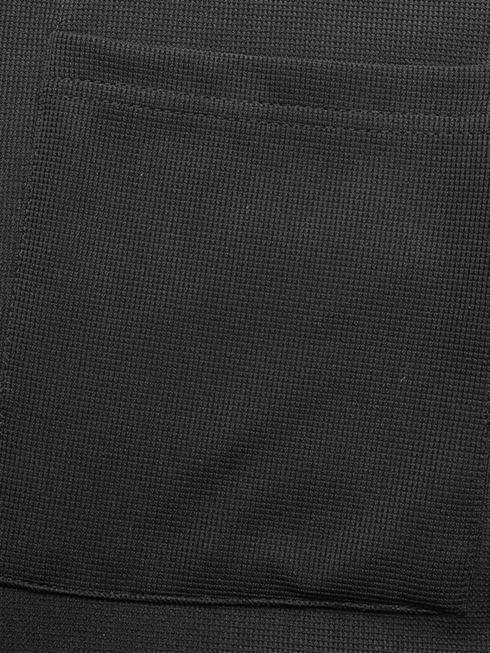 Black textured knit jumpsuit with a visible pocket detail.