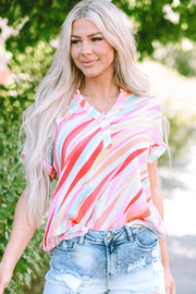 Prismatic stripe Henley blouse in blush pink with short sleeves and a V-neck, styled with denim shorts.