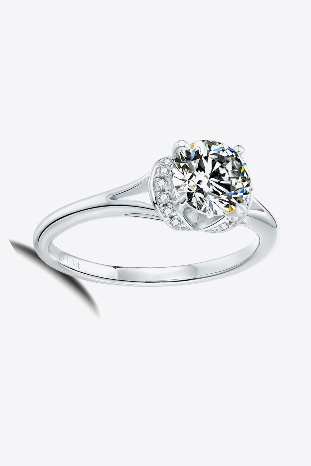 Split shank halo moissanite ring in silver with a round center stone and pavé accents.