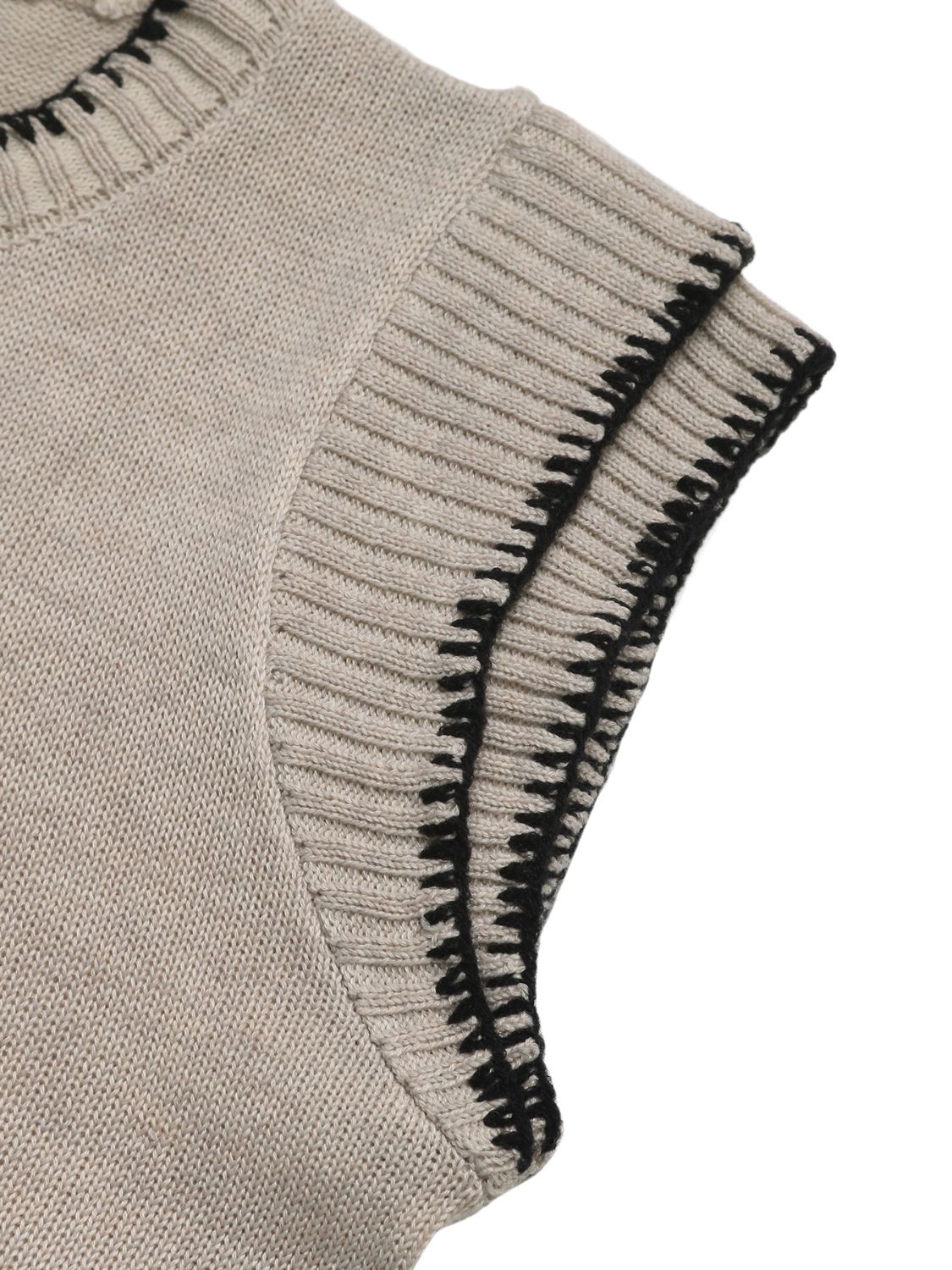Beige knit top with cap sleeves and black stitched edge detail.