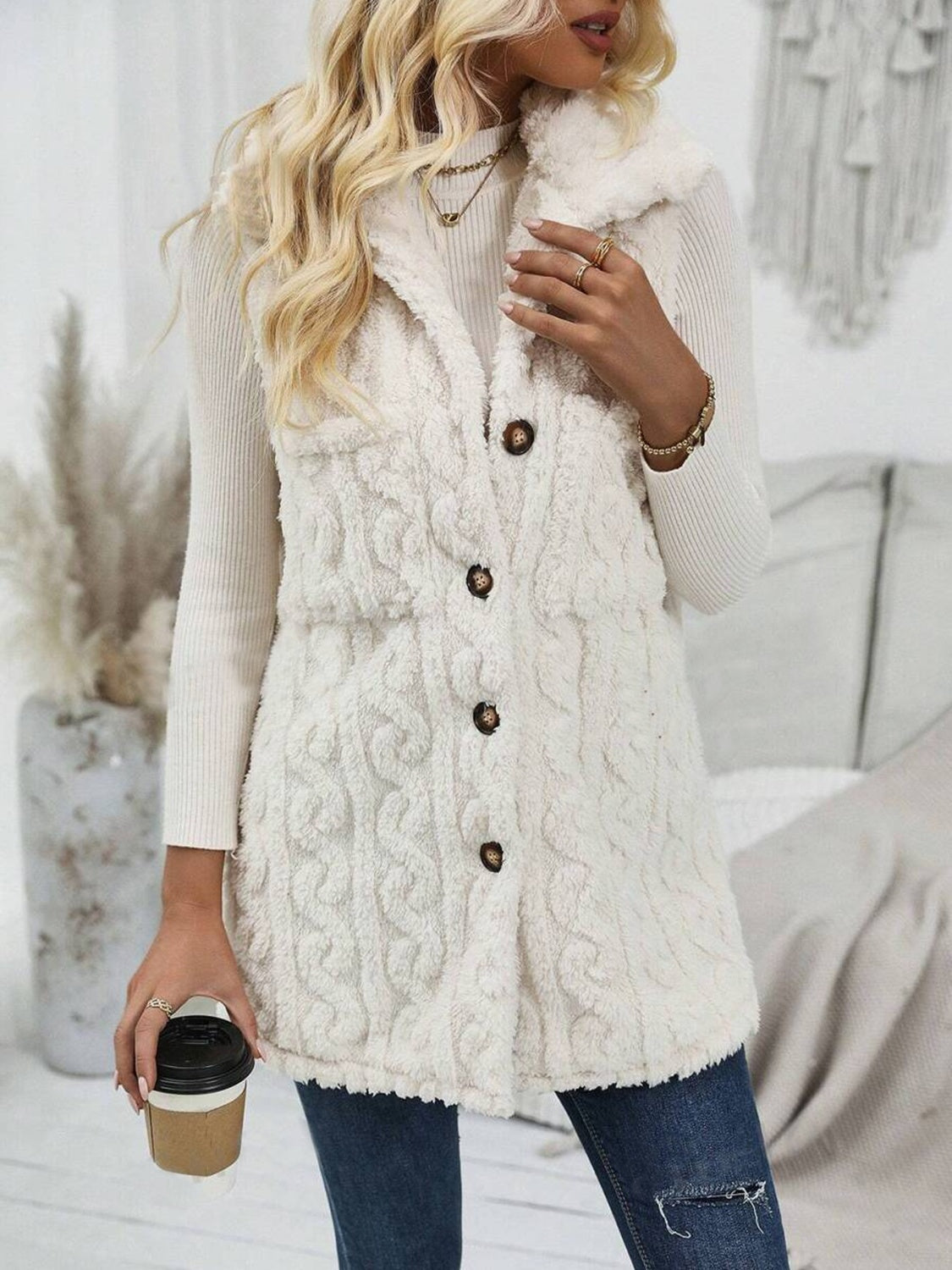 Beige textured sherpa button-down vest with cable knit pattern and collar.