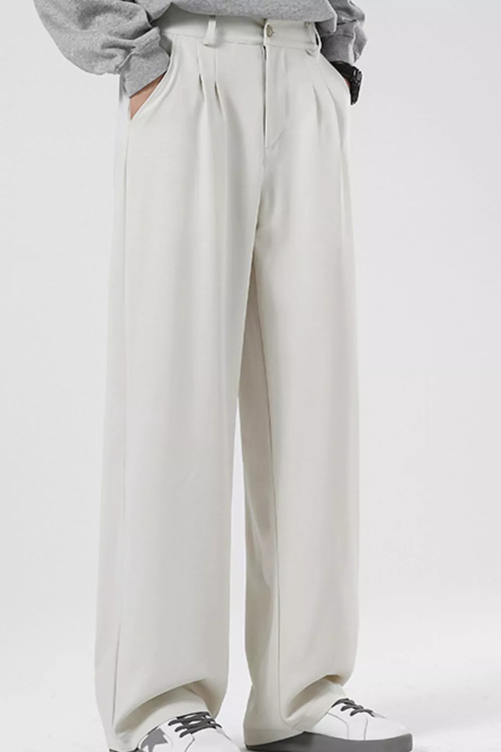 Men's cream pleated casual pants with a wide leg and relaxed fit.