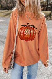 Sequin pumpkin corduroy sweatshirt in sherbet with relaxed fit and long sleeves.