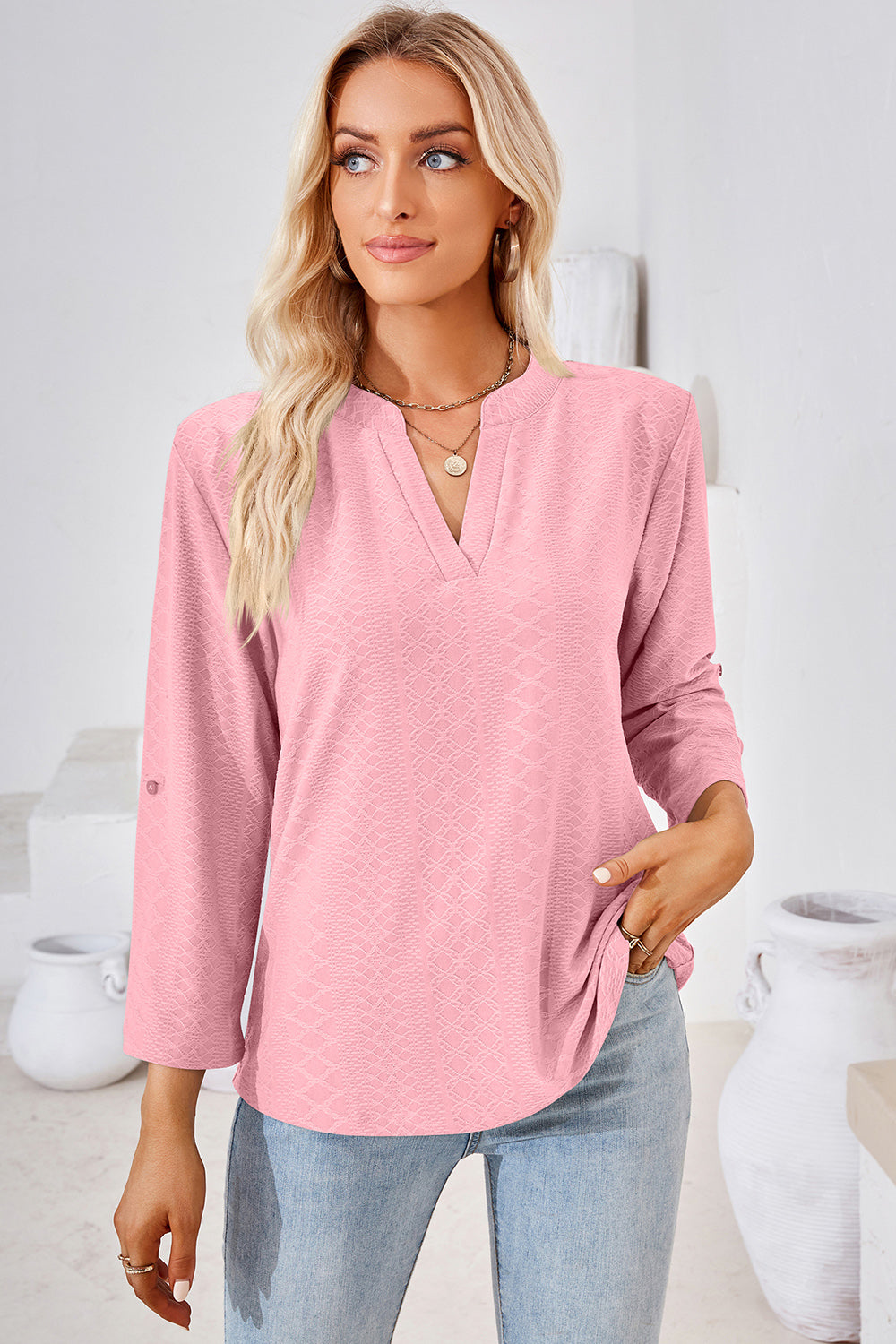 Blush pink textured henley shirt with V-neck and roll-tab sleeves