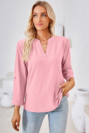 Blush pink textured henley shirt with V-neck and roll-tab sleeves