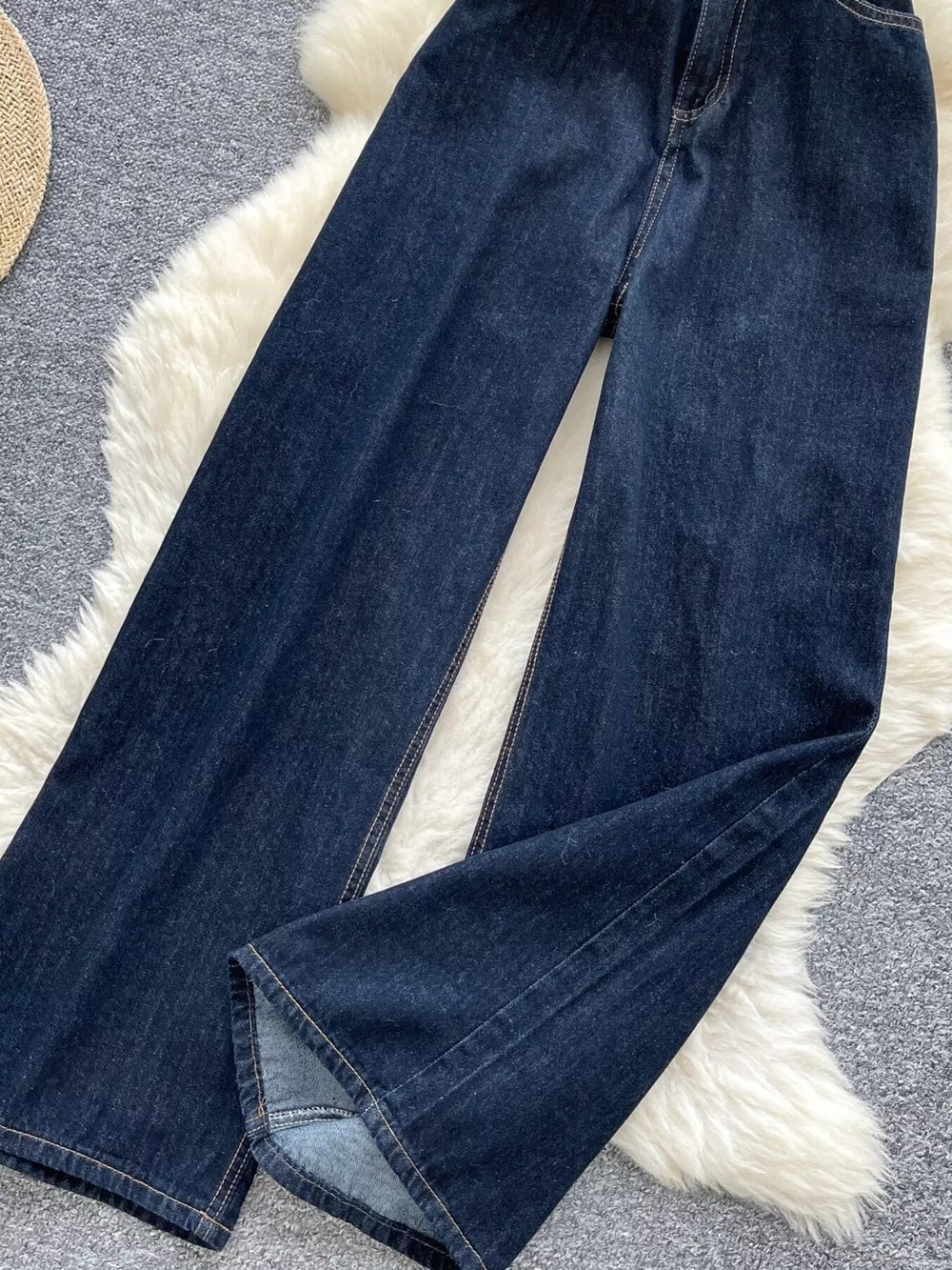 Dark wash maternity jeans with wide legs and a high rise, made of denim.