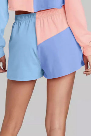 Colorblock lounge shorts in light blue and dusty pink with an elastic waistband.