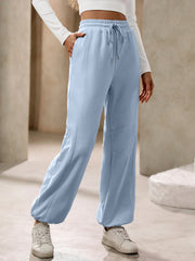 Light blue balloon-leg sweatpants with drawstring waist and pockets.