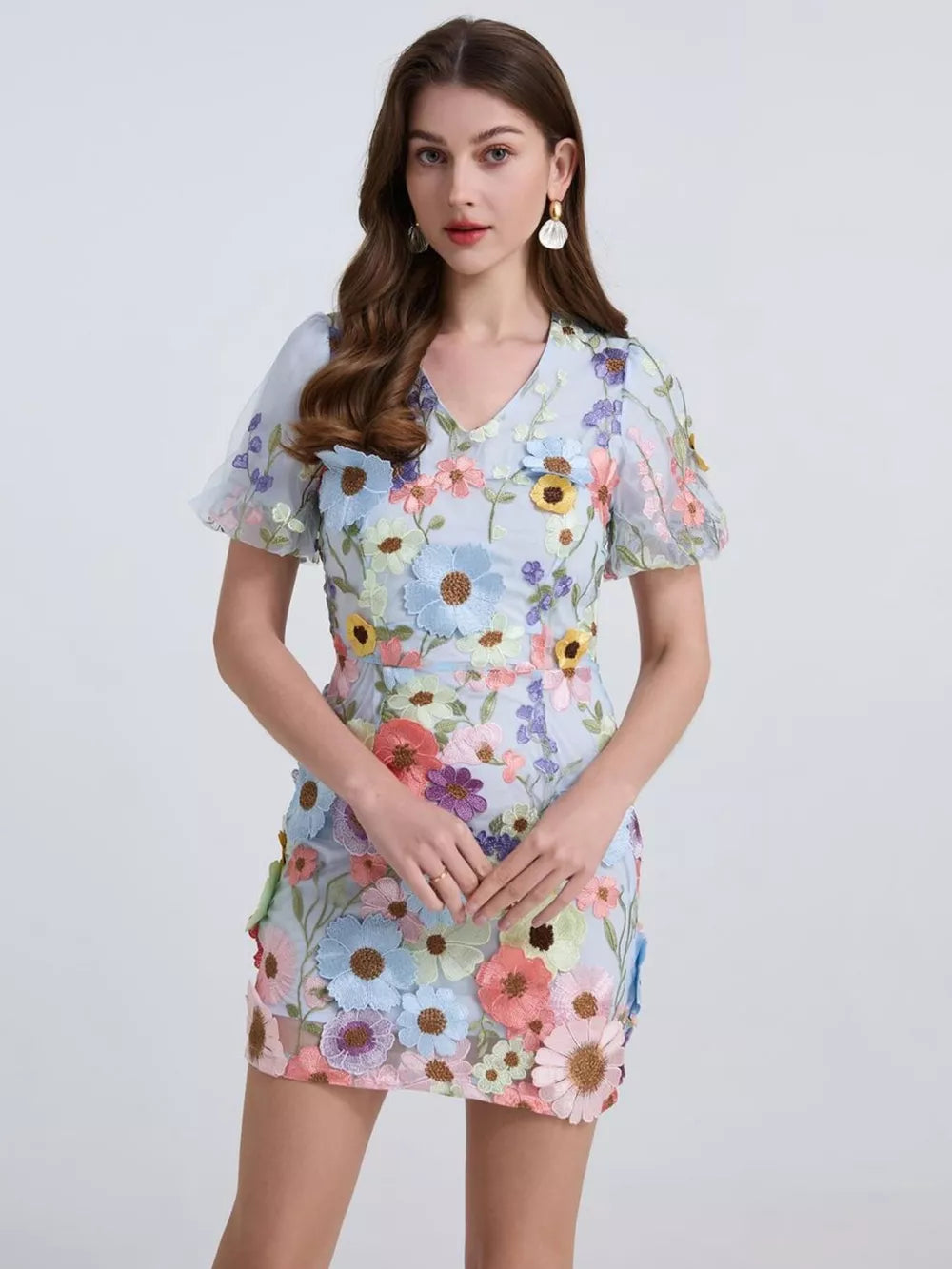 Sky blue mini dress with puff sleeves and colorful floral embroidery.