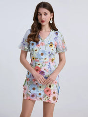 Sky blue mini dress with puff sleeves and colorful floral embroidery.