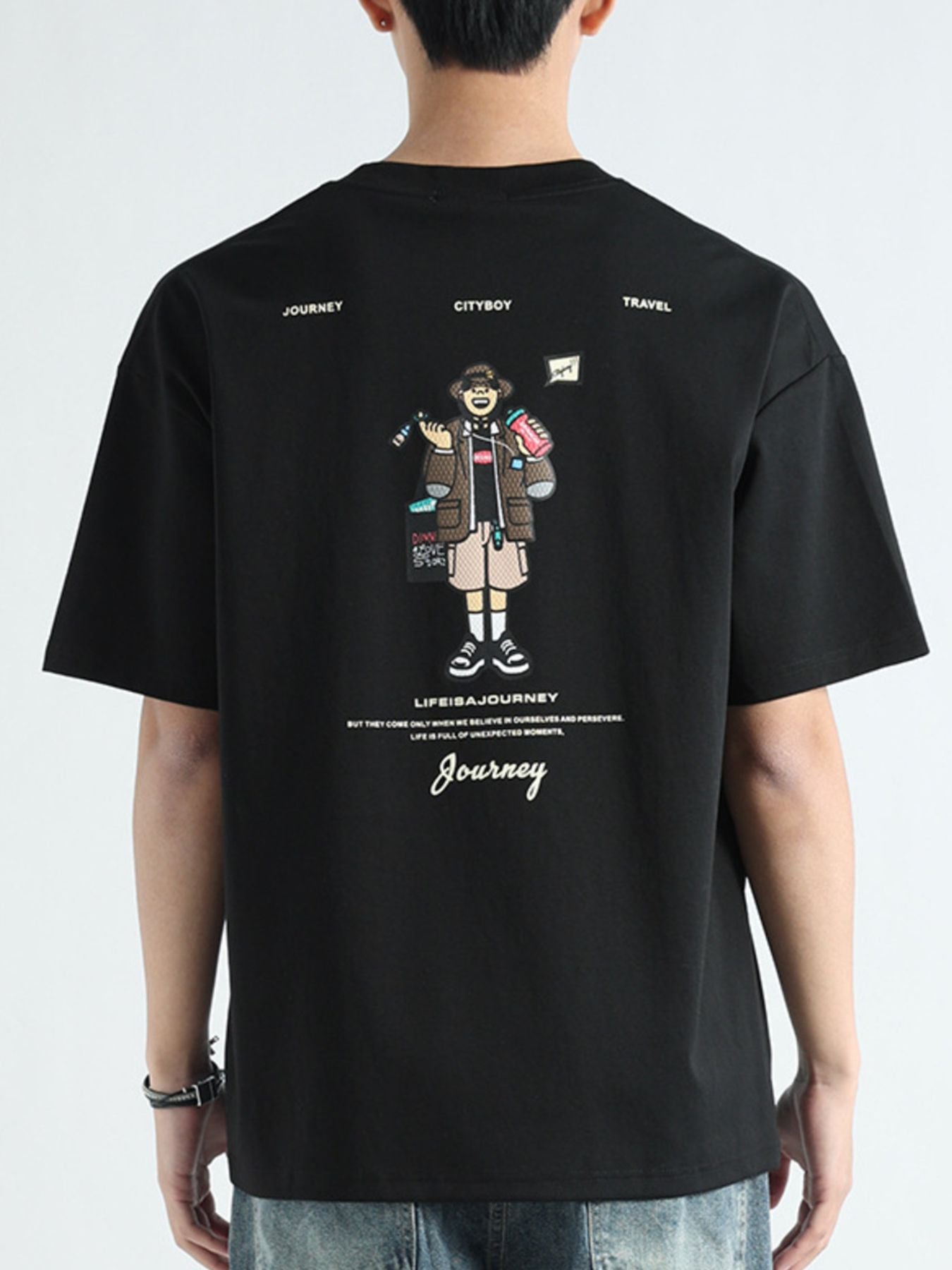 Black cotton t-shirt with graphic print of a traveler and text "LIFEISAJOURNEY Journey