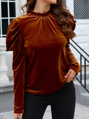 Ruffled velvet mock neck blouse with puff sleeves in brown.