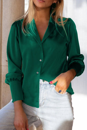 Emerald satin blouse with poet sleeves and button front, styled with light wash jeans.